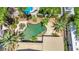 Aerial view of a backyard pool with a spa, surrounded by lush tropical landscaping and a large patio at 8224 Fawn Meadow Ave, Las Vegas, NV 89149