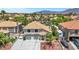 Aerial view of a home with a large driveway, three-car garage, well-maintained landscaping, and an RV parked nearby at 8224 Fawn Meadow Ave, Las Vegas, NV 89149