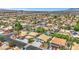 Aerial view of a neighborhood featuring houses with well-maintained landscaping, backyard pools and a mountain backdrop at 8224 Fawn Meadow Ave, Las Vegas, NV 89149