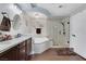 Bathroom features a modern vanity, large tub, glass-enclosed shower, and wood floors at 8224 Fawn Meadow Ave, Las Vegas, NV 89149