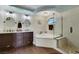 Bright bathroom featuring dual sinks, soaking tub, and separate glass shower at 8224 Fawn Meadow Ave, Las Vegas, NV 89149