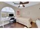 Bedroom featuring hardwood floors, a ceiling fan, and a nice desk with a window at 8224 Fawn Meadow Ave, Las Vegas, NV 89149