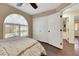 View of a bedroom with wood floors, ceiling fan, a window, and a large closet at 8224 Fawn Meadow Ave, Las Vegas, NV 89149