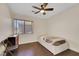 Bedroom features a small twin bed, window with blinds, and wooden floors at 8224 Fawn Meadow Ave, Las Vegas, NV 89149