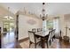 Elegant dining room featuring a chandelier, large table with seating for eight, and natural light at 8224 Fawn Meadow Ave, Las Vegas, NV 89149