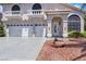 Beautiful home featuring a three-car garage, classic balconies, and inviting front entrance at 8224 Fawn Meadow Ave, Las Vegas, NV 89149