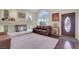Comfortable living room with fireplace, hardwood floors, and a large window at 8224 Fawn Meadow Ave, Las Vegas, NV 89149
