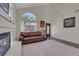 Bright living room boasts a fireplace, rich wood floors, and a large arched window at 8224 Fawn Meadow Ave, Las Vegas, NV 89149