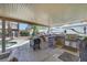 Covered outdoor kitchen with grill, sink, and counter space, perfect for entertaining at 8224 Fawn Meadow Ave, Las Vegas, NV 89149