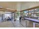 Outdoor kitchen and dining area with BBQ, bar, dining table and pool at 8224 Fawn Meadow Ave, Las Vegas, NV 89149