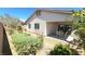 A cozy outdoor patio with a table and chairs, surrounded by a well-kept garden and privacy fence at 8305 Minots Ledge Ave, Las Vegas, NV 89147