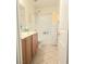 Bathroom features a shower-tub combo, neutral paint, and tile floors at 8305 Minots Ledge Ave, Las Vegas, NV 89147
