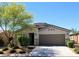 Charming single-story home with a well-maintained lawn and a two-car garage, set against a clear blue sky at 8305 Minots Ledge Ave, Las Vegas, NV 89147