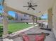 A covered back patio with ceiling fans and an outdoor dining set at 8481 Lambert Dr, Las Vegas, NV 89147