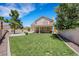 A well-maintained backyard with lush green lawn and a covered patio area at 8481 Lambert Dr, Las Vegas, NV 89147