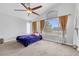 Bedroom with a ceiling fan, a window with curtains, and carpeted floors at 8481 Lambert Dr, Las Vegas, NV 89147
