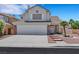 Charming two-story home featuring a three-car garage and desert landscaping at 8481 Lambert Dr, Las Vegas, NV 89147