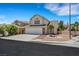 Corner lot home boasting a two-car garage, desert landscaping and nearby street sign at 8481 Lambert Dr, Las Vegas, NV 89147