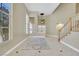 A spacious foyer featuring tile floors, high ceilings, and a staircase at 8481 Lambert Dr, Las Vegas, NV 89147