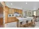 Traditional kitchen with wood cabinets, white countertops, island with seating, and modern appliances at 8481 Lambert Dr, Las Vegas, NV 89147