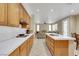 Open kitchen with modern tile counters and stainless steel appliances at 8481 Lambert Dr, Las Vegas, NV 89147