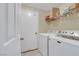 Clean laundry room with a washer, dryer, and wire shelving at 8481 Lambert Dr, Las Vegas, NV 89147
