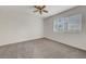 Carpeted bedroom featuring a window with blinds and neutral paint at 8600 W Charleston Blvd # 1128, Las Vegas, NV 89117