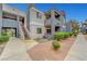 Multi-level condo building with well-maintained landscaping and a walkway to the entrance at 8600 W Charleston Blvd # 1128, Las Vegas, NV 89117