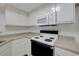 Well-equipped kitchen with modern electric range and microwave, paired with plentiful white cabinetry at 8600 W Charleston Blvd # 1128, Las Vegas, NV 89117