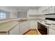 Well-lit kitchen featuring a double sink, white cabinets, and wood-look flooring for a clean, modern aesthetic at 8600 W Charleston Blvd # 1128, Las Vegas, NV 89117