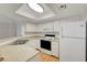 Bright kitchen with white cabinets, laminate countertops, and essential appliances, including a microwave and refrigerator at 8600 W Charleston Blvd # 1128, Las Vegas, NV 89117