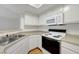 A bright kitchen featuring modern appliances, laminate countertops, and white cabinetry with ample storage at 8600 W Charleston Blvd # 1128, Las Vegas, NV 89117