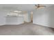 Spacious living room featuring neutral carpeting, a ceiling fan, and an open layout to the kitchen at 8600 W Charleston Blvd # 1128, Las Vegas, NV 89117