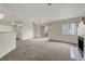 Living room features a ceiling fan, neutral carpet, fireplace, and natural light at 8600 W Charleston Blvd # 1128, Las Vegas, NV 89117