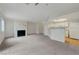 Spacious living room featuring a fireplace, carpet, and an open view to the kitchen at 8600 W Charleston Blvd # 1128, Las Vegas, NV 89117