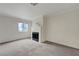 Bright living room features neutral carpet, crown molding, and a decorative fireplace at 8600 W Charleston Blvd # 1128, Las Vegas, NV 89117