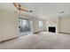 Inviting living room with a sliding door, neutral carpet, and a modern fireplace at 8600 W Charleston Blvd # 1128, Las Vegas, NV 89117