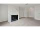 Open-concept living space with a fireplace, neutral carpet, and access to other rooms at 8600 W Charleston Blvd # 1128, Las Vegas, NV 89117