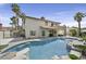 Inviting backyard with a sparkling pool, rock waterfall, outdoor bar, and covered patio at 928 Aspen Valley Ave, Las Vegas, NV 89123