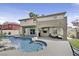 Backyard featuring a pool, rock waterfall, and a covered patio, perfect for outdoor gatherings at 928 Aspen Valley Ave, Las Vegas, NV 89123