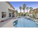 An expansive backyard area featuring a pristine pool with waterfall, covered patio, and ample seating at 928 Aspen Valley Ave, Las Vegas, NV 89123