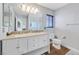 Bathroom features a dual sink vanity, a marble shower, and wood floors at 928 Aspen Valley Ave, Las Vegas, NV 89123