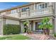 Inviting two-story home featuring a covered porch and balcony, surrounded by lush desert landscaping at 928 Aspen Valley Ave, Las Vegas, NV 89123