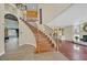 Elegant foyer with hardwood floors, a curved staircase, and an open view to the living room at 928 Aspen Valley Ave, Las Vegas, NV 89123