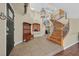 Spacious foyer featuring tile floors, a grand staircase, and a coat rack with seating at 928 Aspen Valley Ave, Las Vegas, NV 89123