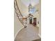 Bright foyer with tiled floors, coat rack and staircase bathed in natural light from a high window at 928 Aspen Valley Ave, Las Vegas, NV 89123