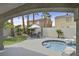 Charming backyard with hot tub, patio area, and lush palm trees, perfect for outdoor living at 928 Aspen Valley Ave, Las Vegas, NV 89123