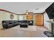 Spacious living room features a dark leather sectional sofa and ceiling fan at 928 Aspen Valley Ave, Las Vegas, NV 89123