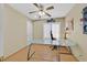 Small office with glass desk, ceiling fan, and neutral wall color at 928 Aspen Valley Ave, Las Vegas, NV 89123