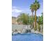 Beautiful pool with a waterfall and palm trees offering a relaxing backyard oasis at 928 Aspen Valley Ave, Las Vegas, NV 89123